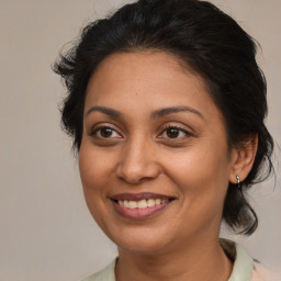 Joyful white adult female with medium  brown hair and brown eyes