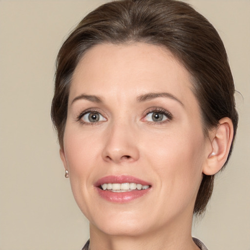 Joyful white adult female with medium  brown hair and brown eyes