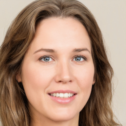 Joyful white young-adult female with long  brown hair and green eyes