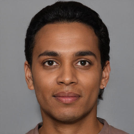 Joyful latino young-adult male with short  black hair and brown eyes