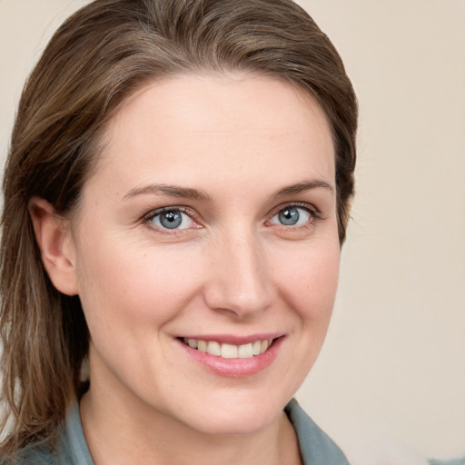 Joyful white young-adult female with medium  brown hair and blue eyes