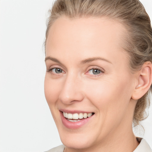 Joyful white young-adult female with medium  brown hair and blue eyes