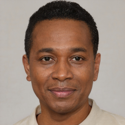 Joyful black adult male with short  black hair and brown eyes