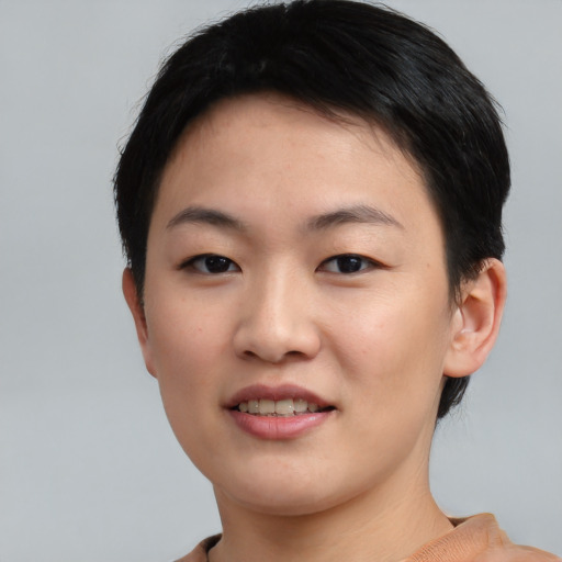 Joyful asian young-adult female with short  black hair and brown eyes