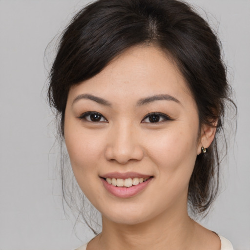 Joyful asian young-adult female with medium  brown hair and brown eyes