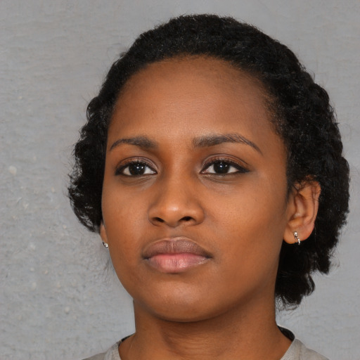 Neutral black young-adult female with medium  black hair and brown eyes