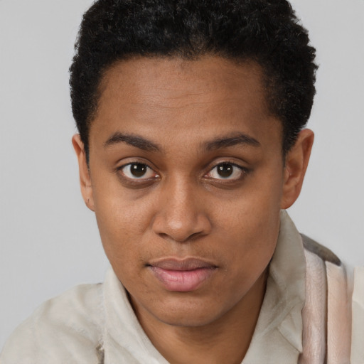 Joyful black young-adult female with short  brown hair and brown eyes