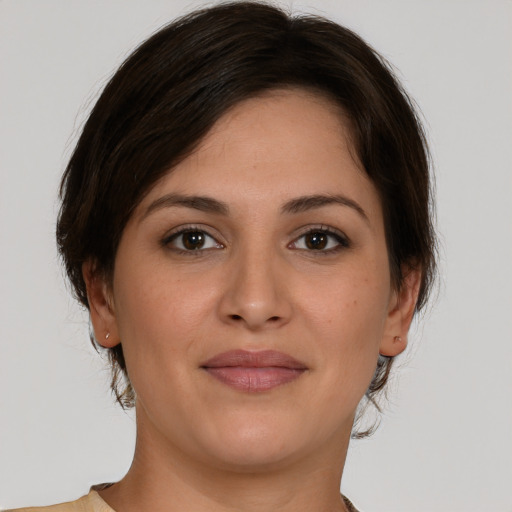 Joyful white young-adult female with medium  brown hair and brown eyes
