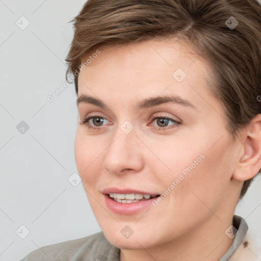 Joyful white young-adult female with short  brown hair and grey eyes