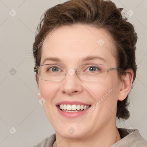 Joyful white adult female with medium  brown hair and blue eyes