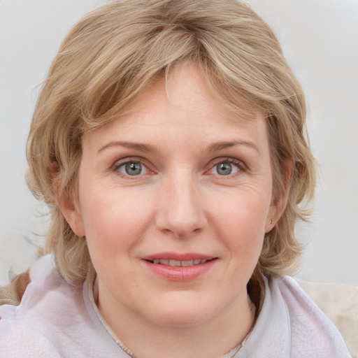 Joyful white young-adult female with medium  brown hair and blue eyes