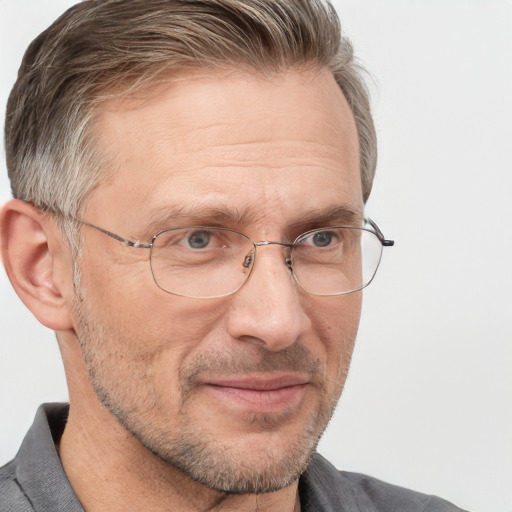 Joyful white middle-aged male with short  brown hair and blue eyes