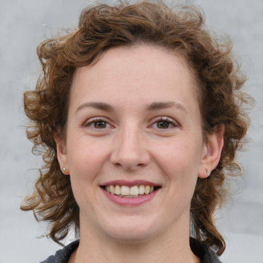 Joyful white young-adult female with medium  brown hair and blue eyes