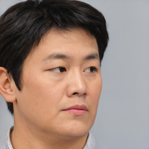 Neutral asian young-adult male with short  brown hair and brown eyes