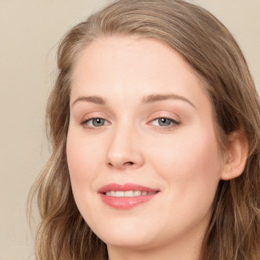 Joyful white young-adult female with long  brown hair and green eyes