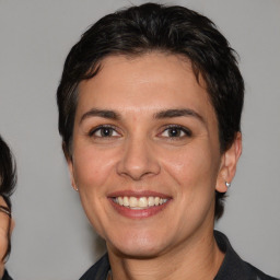 Joyful white adult female with medium  brown hair and brown eyes