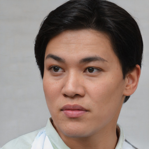 Joyful asian young-adult female with short  brown hair and brown eyes