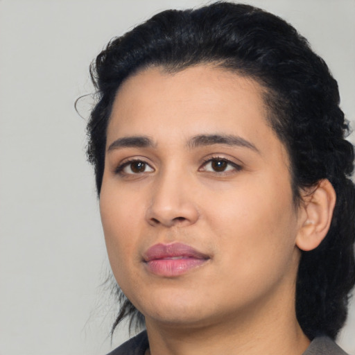 Joyful latino young-adult female with medium  black hair and brown eyes
