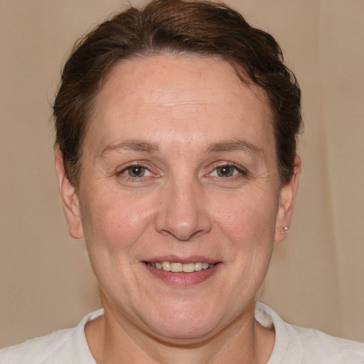 Joyful white adult female with short  brown hair and brown eyes