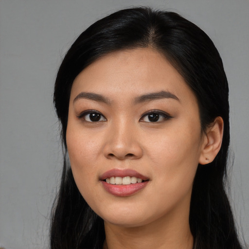 Joyful asian young-adult female with long  black hair and brown eyes