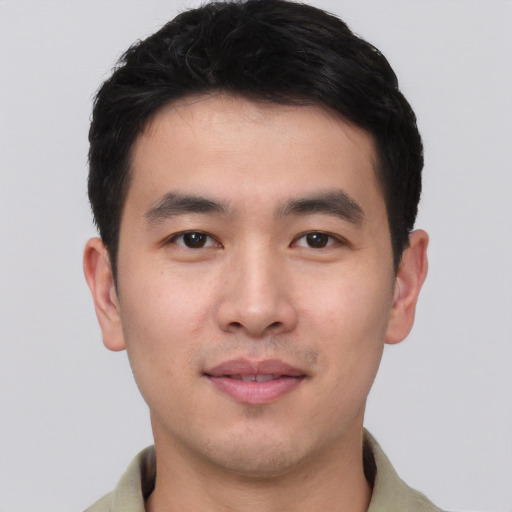 Joyful asian young-adult male with short  black hair and brown eyes