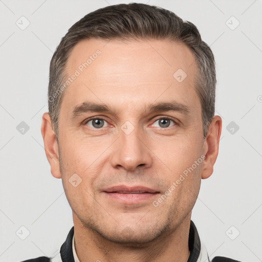 Joyful white adult male with short  brown hair and brown eyes