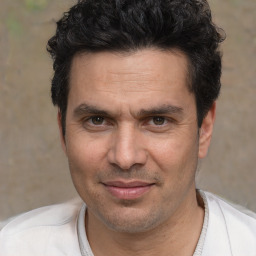 Joyful white adult male with short  black hair and brown eyes