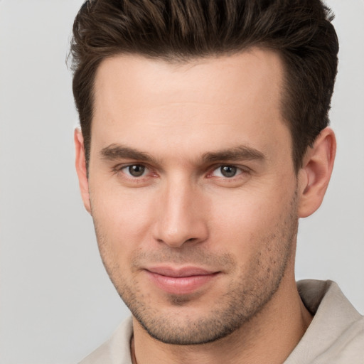 Joyful white young-adult male with short  brown hair and brown eyes