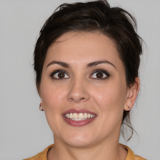 Joyful white young-adult female with medium  brown hair and brown eyes