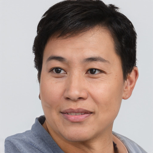 Joyful asian adult male with short  brown hair and brown eyes