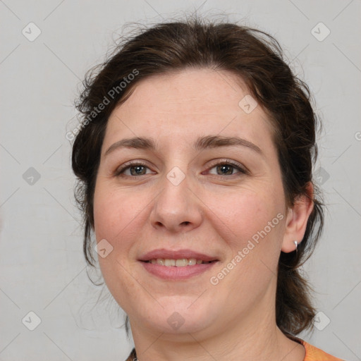 Joyful white adult female with medium  brown hair and grey eyes