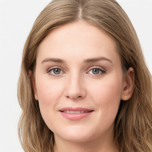 Joyful white young-adult female with long  brown hair and blue eyes