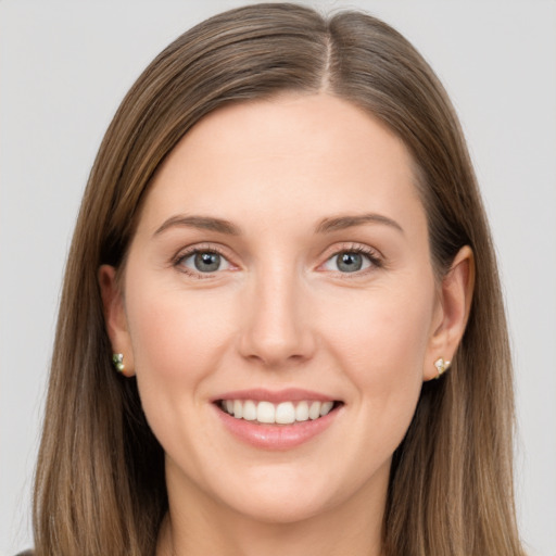 Joyful white young-adult female with long  brown hair and grey eyes