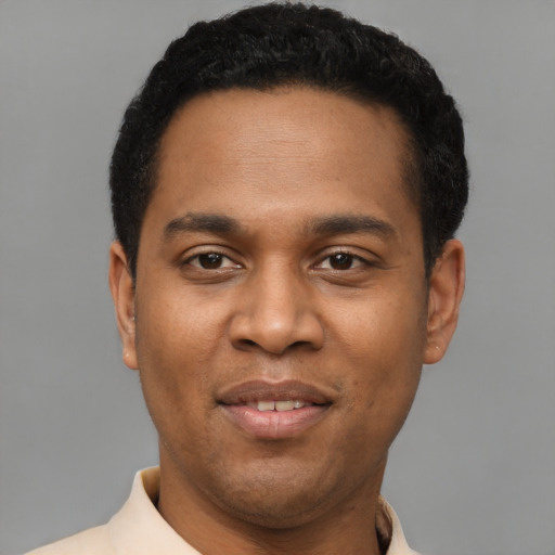 Joyful latino young-adult male with short  black hair and brown eyes