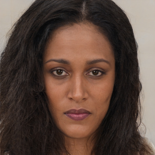 Neutral black young-adult female with long  brown hair and brown eyes