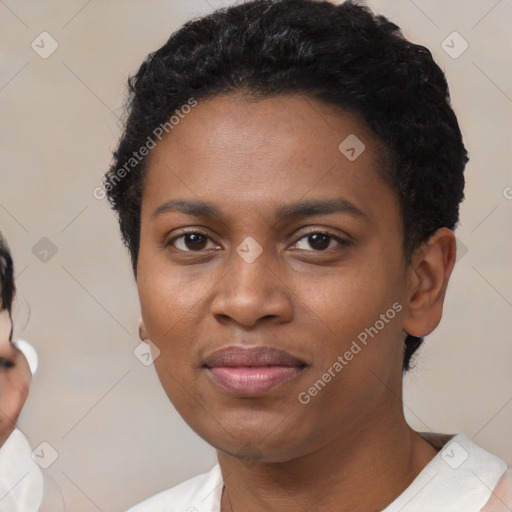 Joyful black young-adult female with short  black hair and brown eyes