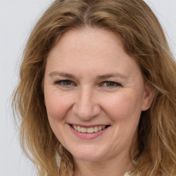 Joyful white adult female with long  brown hair and brown eyes