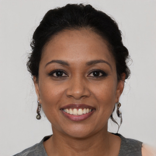 Joyful latino young-adult female with medium  black hair and brown eyes