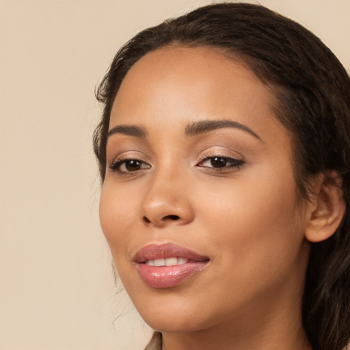 Joyful latino young-adult female with long  brown hair and brown eyes