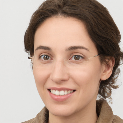 Joyful white young-adult female with medium  brown hair and grey eyes