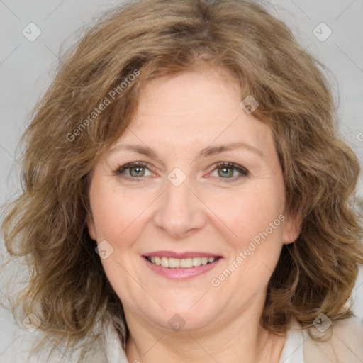 Joyful white adult female with medium  brown hair and green eyes