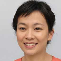 Joyful asian young-adult female with short  brown hair and brown eyes