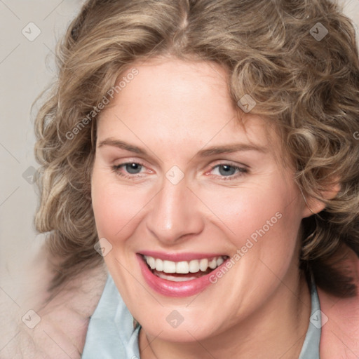 Joyful white adult female with medium  brown hair and blue eyes