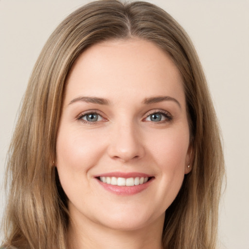 Joyful white young-adult female with long  brown hair and grey eyes