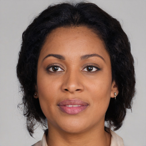 Joyful black young-adult female with medium  brown hair and brown eyes