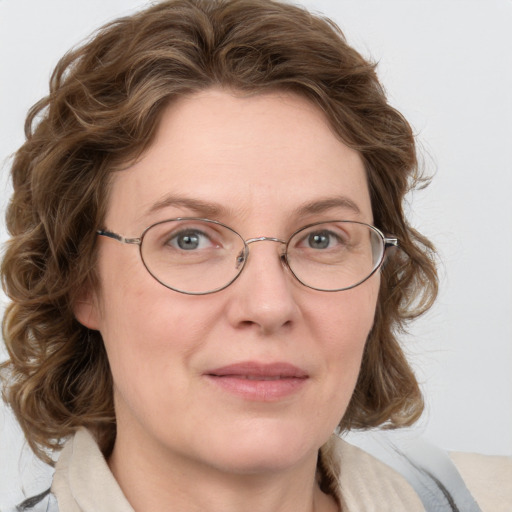 Joyful white adult female with medium  brown hair and blue eyes