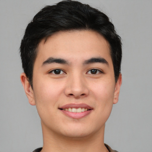 Joyful asian young-adult male with short  black hair and brown eyes