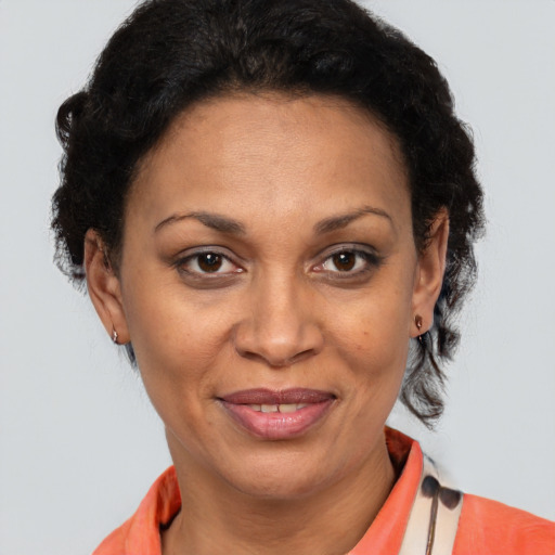 Joyful latino adult female with short  brown hair and brown eyes