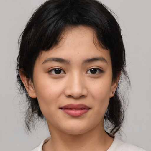 Joyful asian young-adult female with medium  black hair and brown eyes