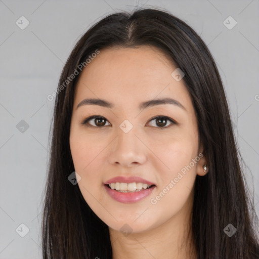 Joyful asian young-adult female with long  brown hair and brown eyes